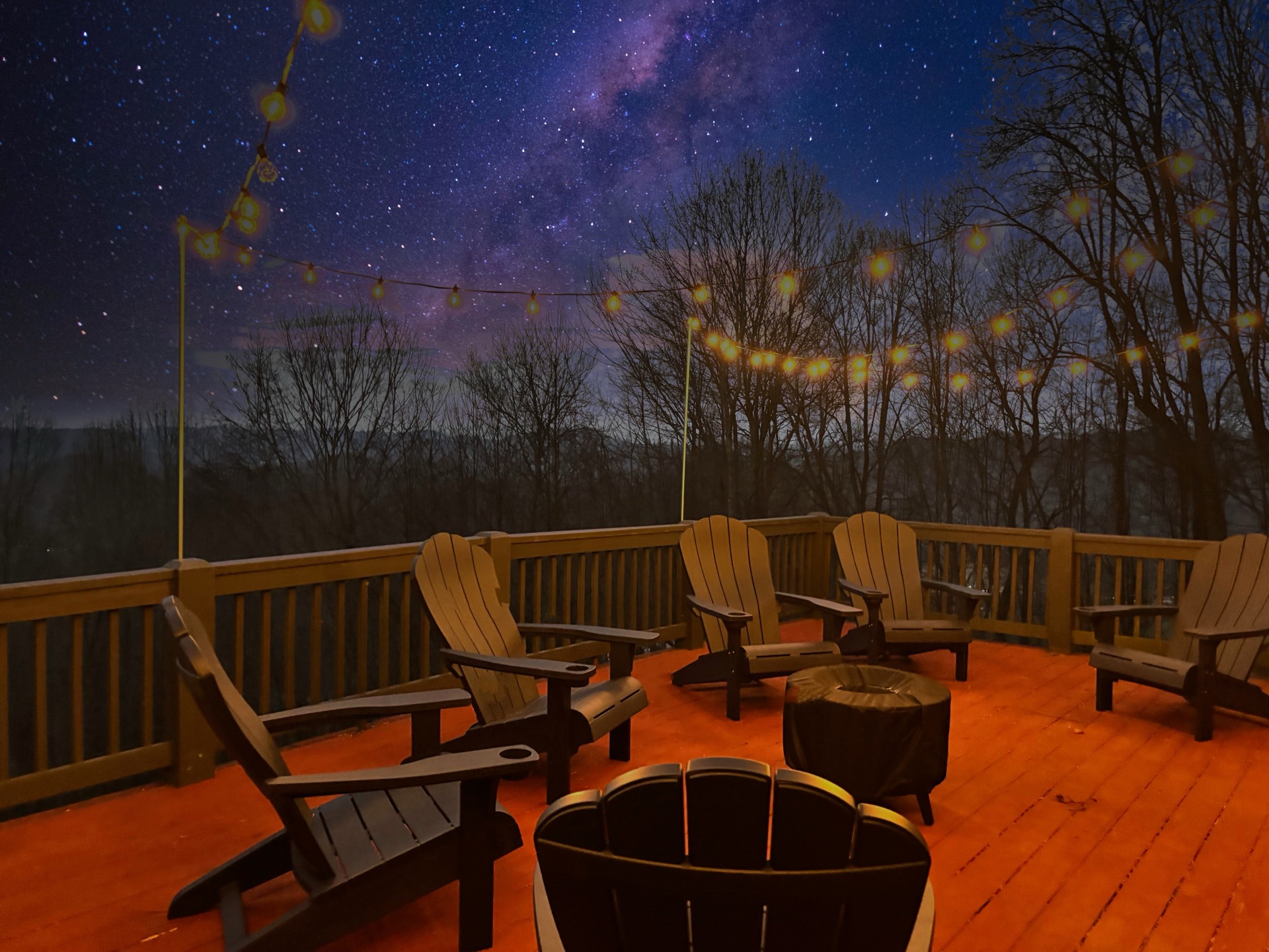 Deck with Adirondack chairs under the Milky Way